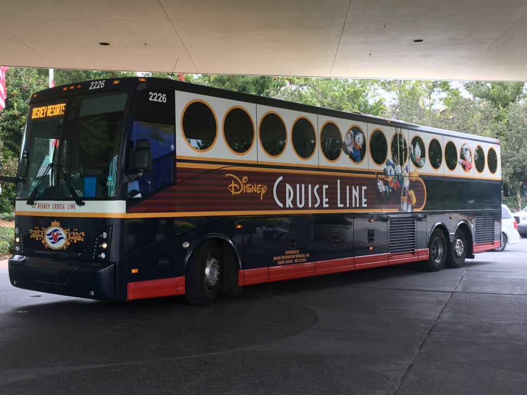 Disney Cruise Line transfer bus picking up guests at a Walt Disney World Resort for transportation to the cruise terminal